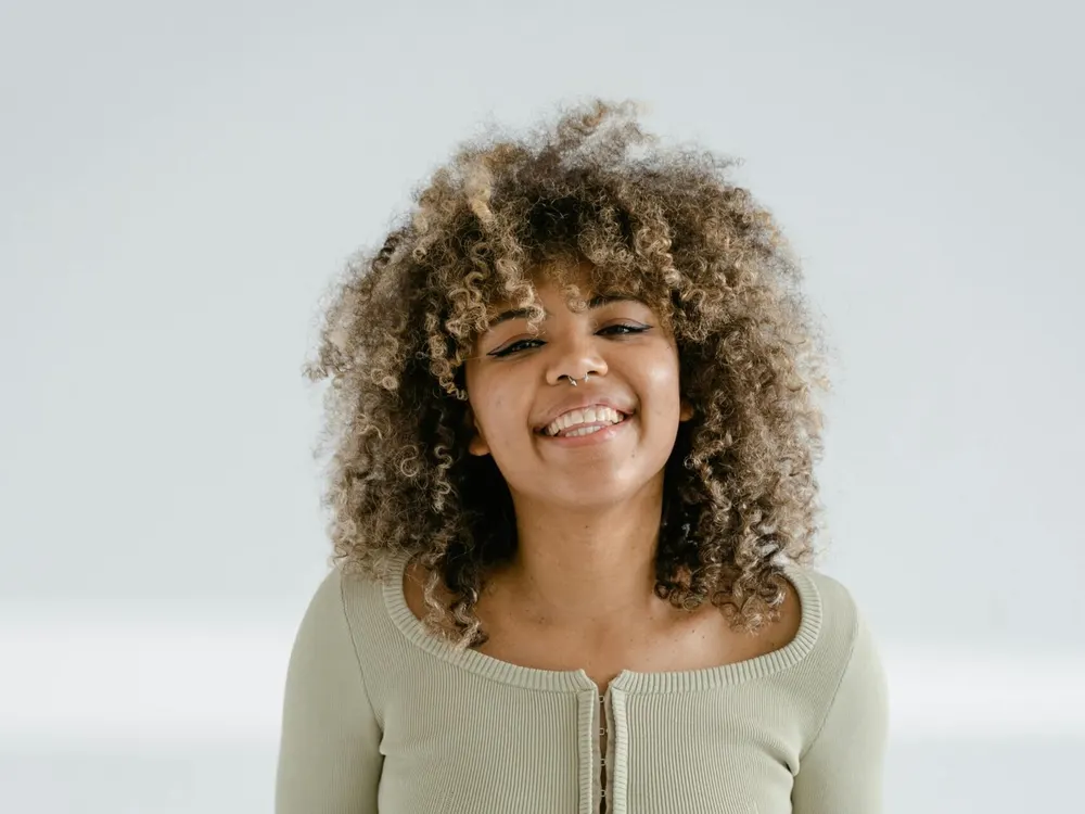 Model wearing a hand-finished curly custom wig